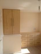 A cupboard fitted on top of the stairs box with a 3 column matching chest of drawers